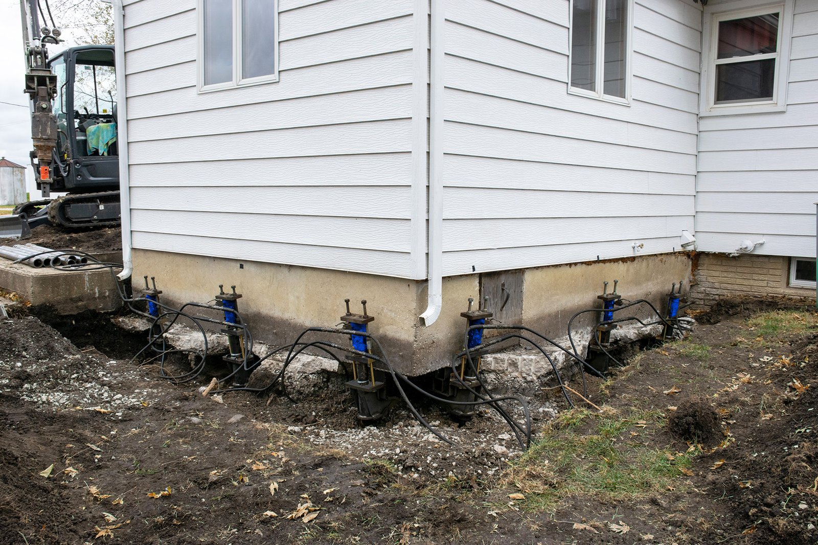 Before and after of a foundation piering job
